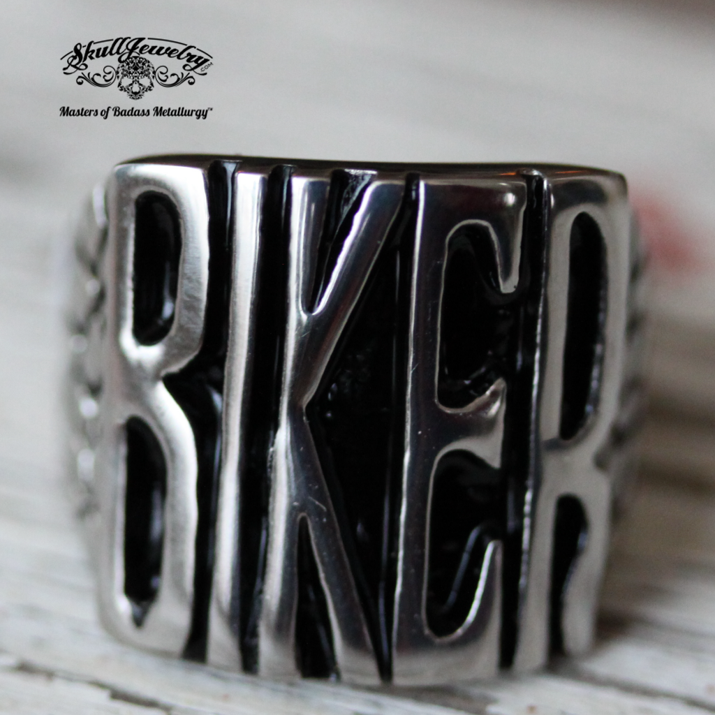 badass biker stainless steel ring sitting on vintage wood