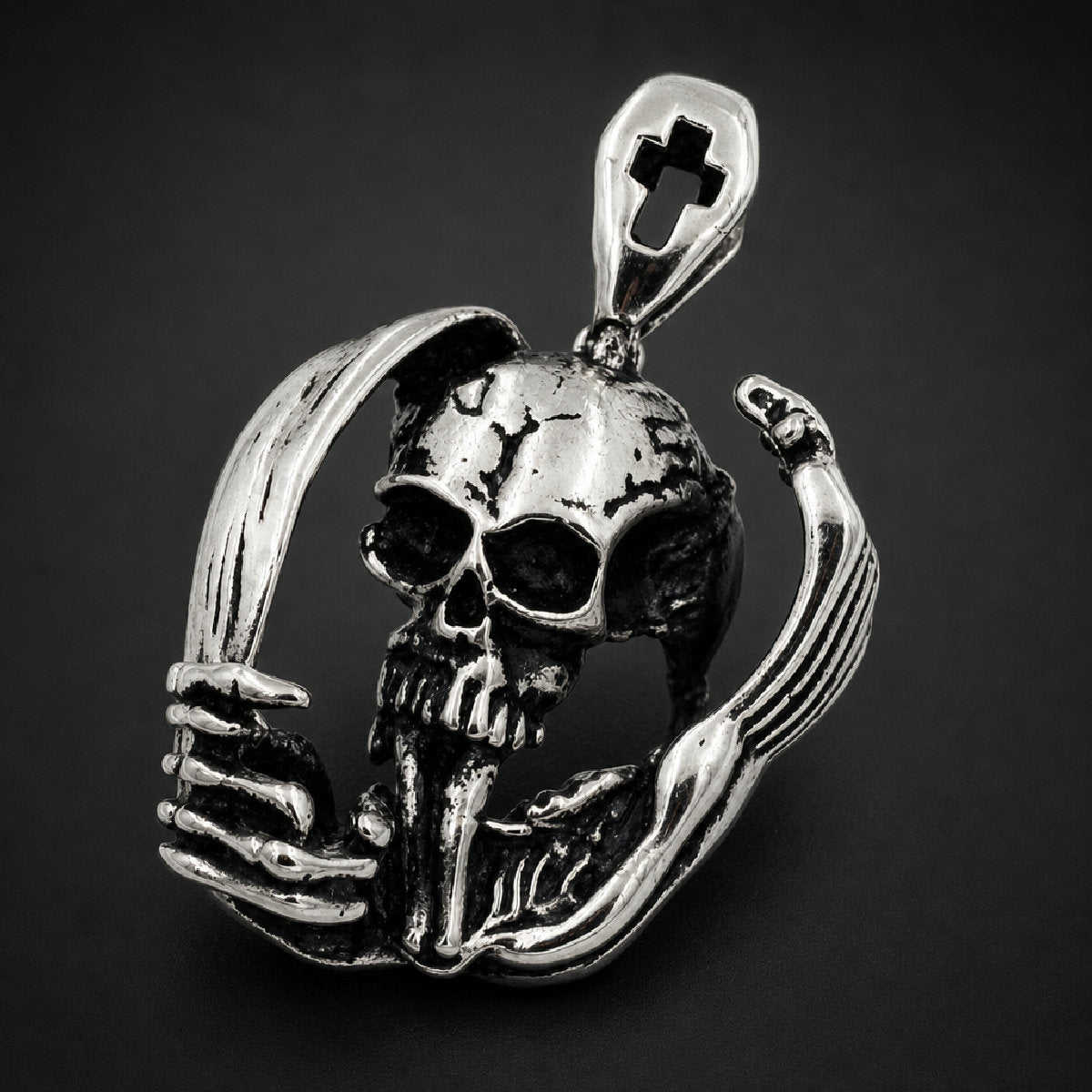 316L stainless steel cranium pendant enclosed in curved skeletal hands with cross cutout bail