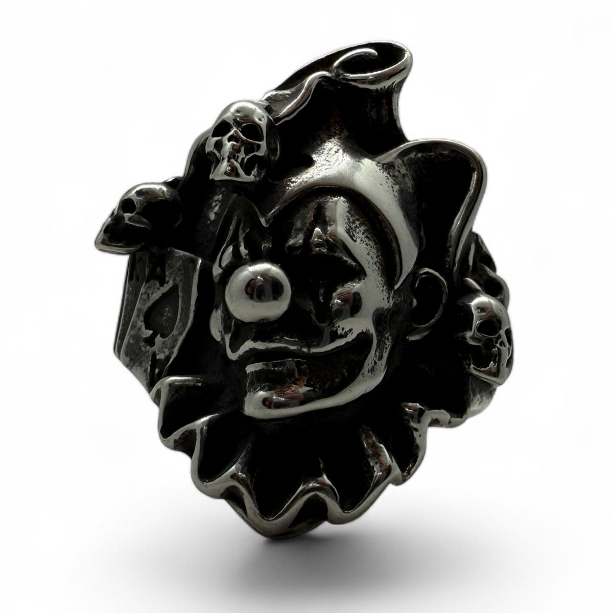 Side angle of creepy clown face ring with skull accents and playing card – perfect for horror fans or bikers
