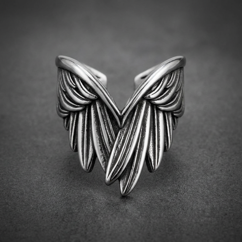 Heavy-duty 316L stainless steel ring with two intricately sculpted, dark-finished wings, extending outward from a polished band, HardKnocker™ style.