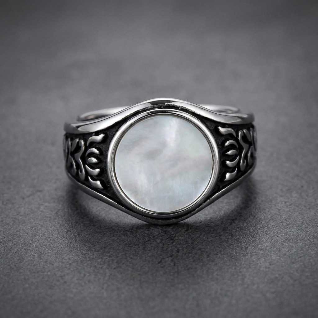 HardKnocker 316L stainless steel ring with a central iridescent mother-of-pearl style panel, framed by a high-polish bezel. The ring band features deep, dark, etched flowing patterns on both sides, with a polished wave-like top and bottom edge.