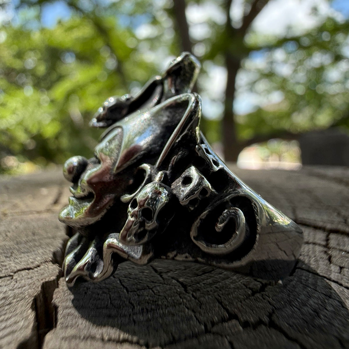Closeup side view of evil joker ring with skulls and twisted grin – horror-themed stainless steel ring