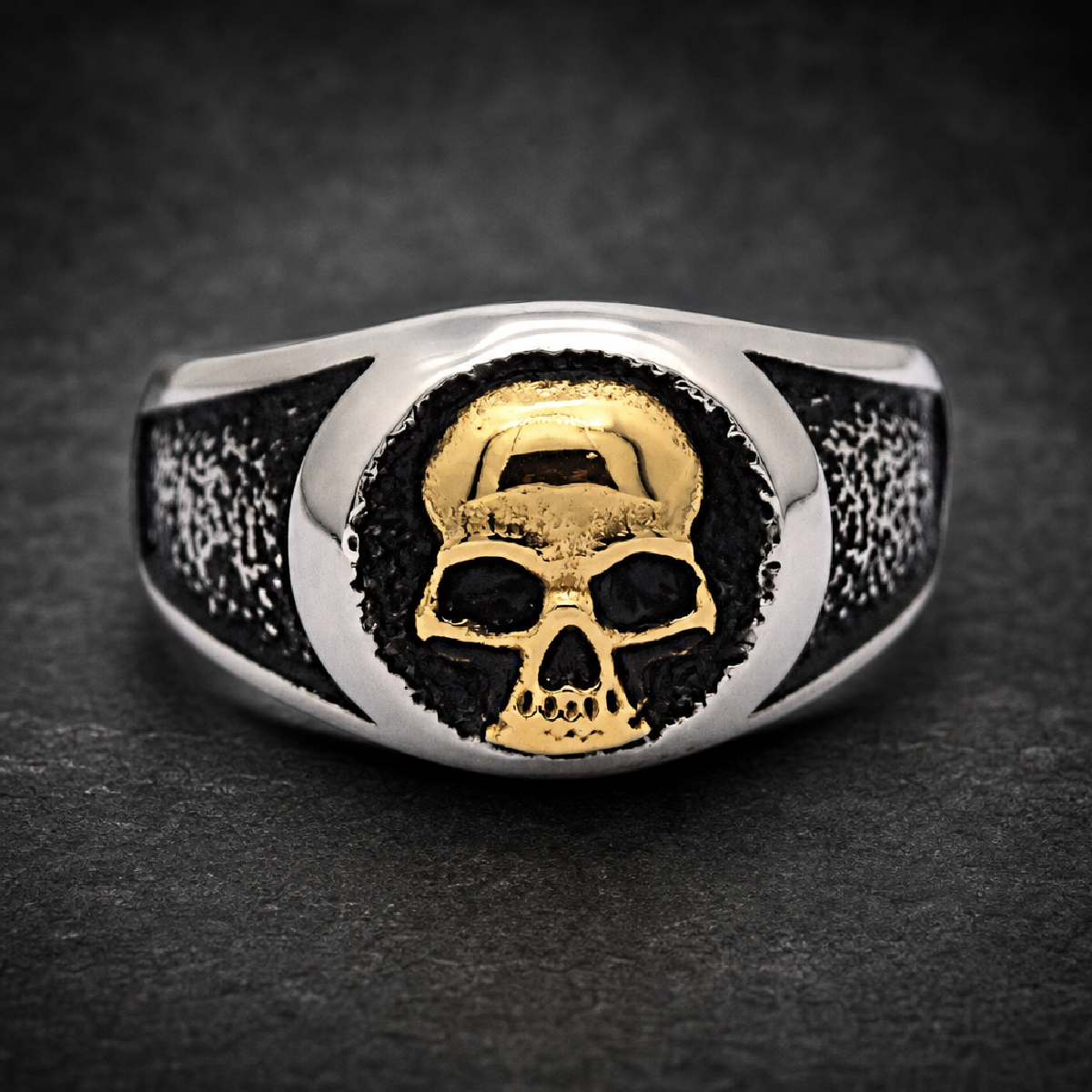 Unisex two-tone gold face skull ring in 316L surgical stainless steel, with a black oxidized and textured band.