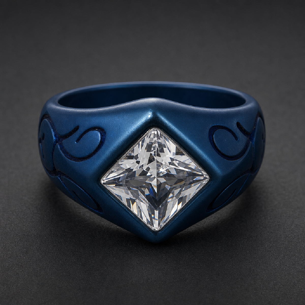 Blue Blood Signet, matte blue 316L surgical stainless steel ring with a large, clear square gemstone and embossed side patterns on a dark background.