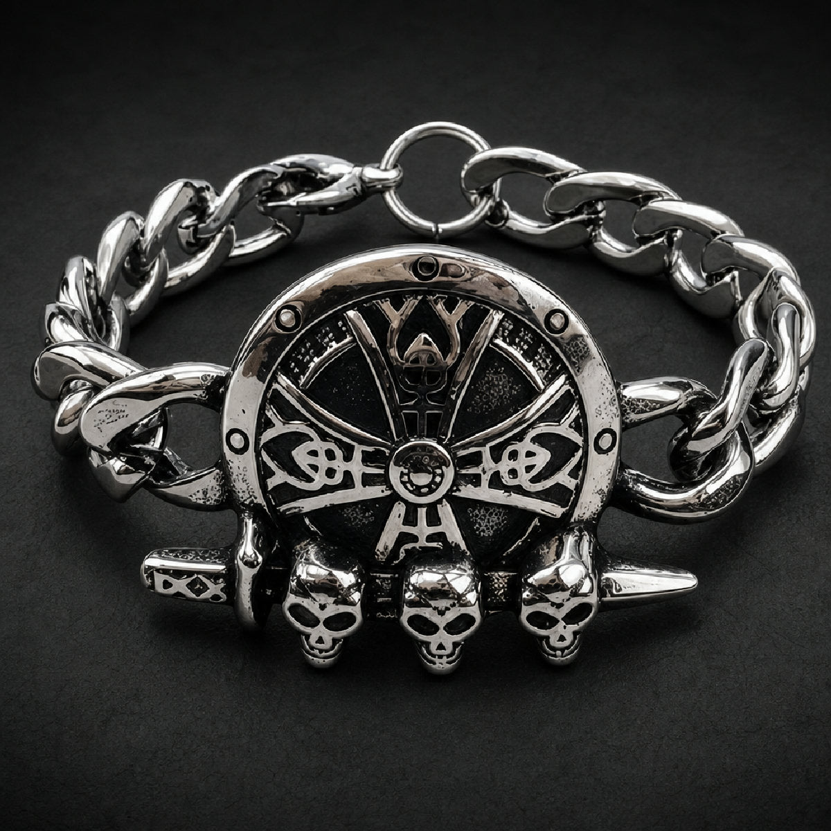 316L stainless steel unisex curb chain bracelet with circular shield emblem and three skulls across a dagger