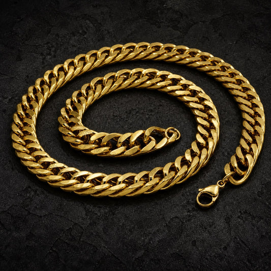 A thick gold Cuban link chain necklace coiled on a dark textured background, featuring a lobster clasp at one end.