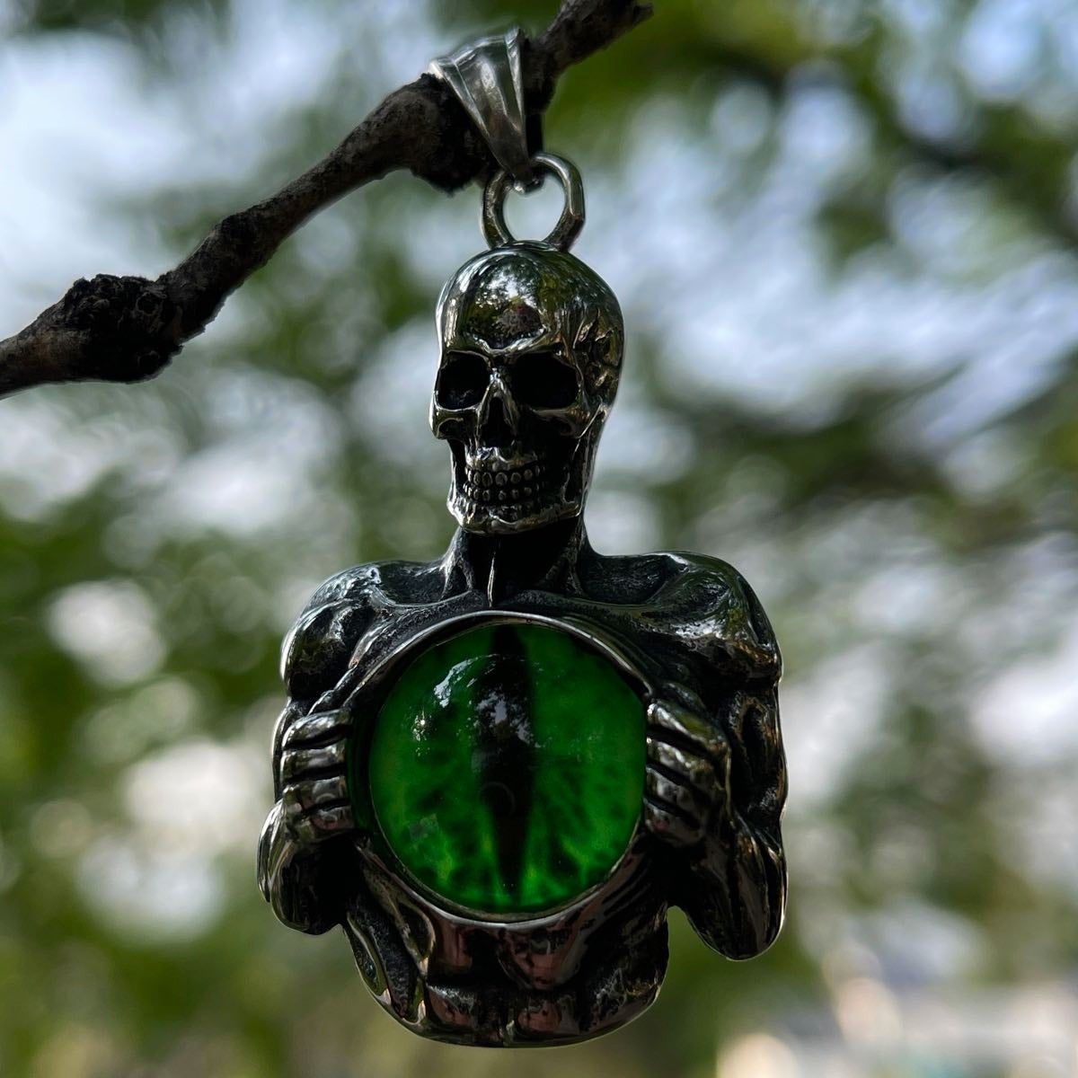 Skeleton Holding Green Dragon Eye Pendant