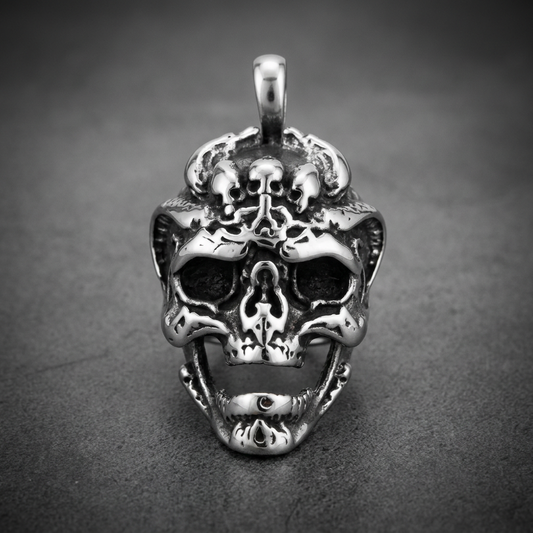 Aegis Skull stainless steel pendant, highly detailed skull with organic molten metal textures, dark recesses, and high polish highlights.