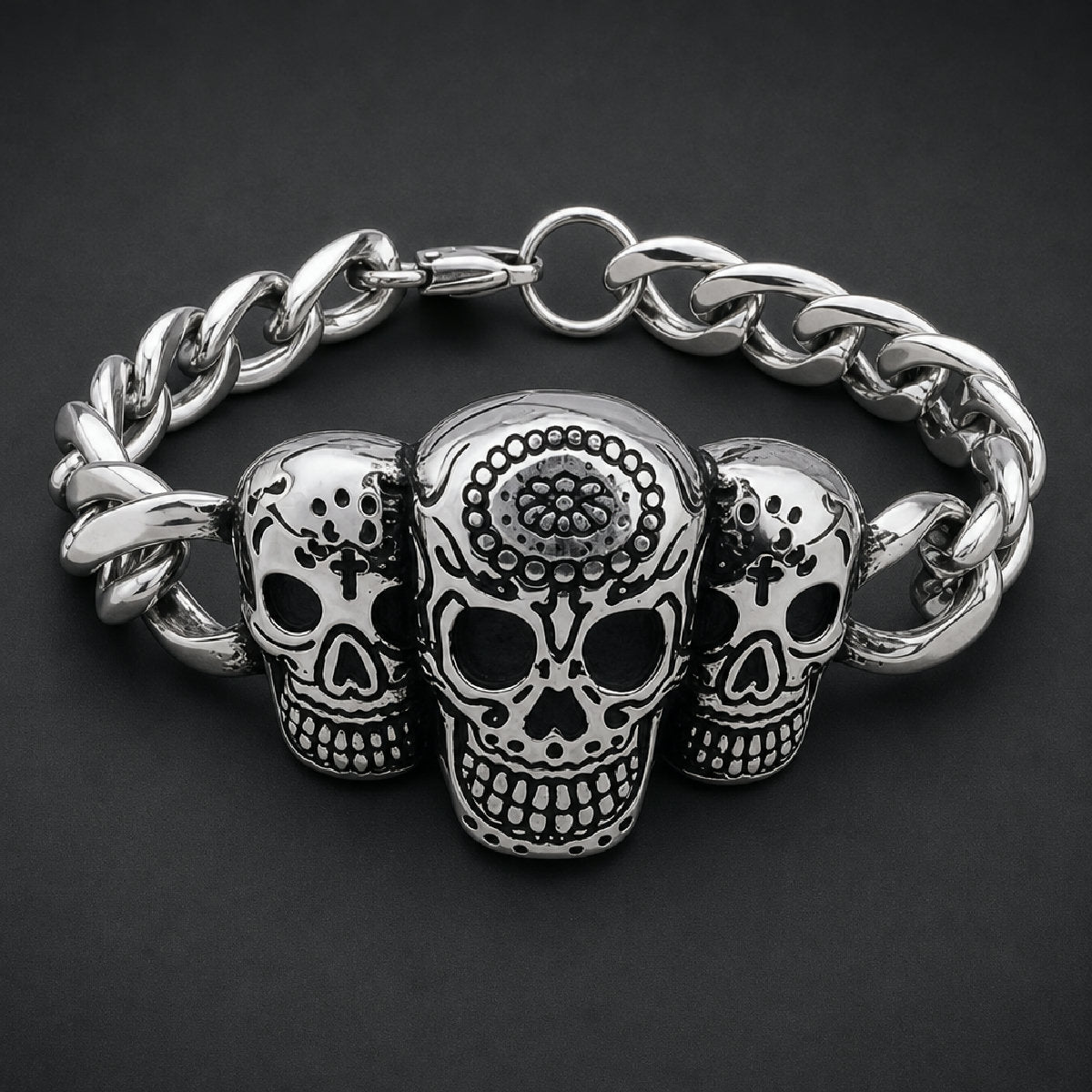 Solid 316L surgical stainless steel unisex bracelet featuring three detailed sugar skulls with floral carvings on a heavy curb link band