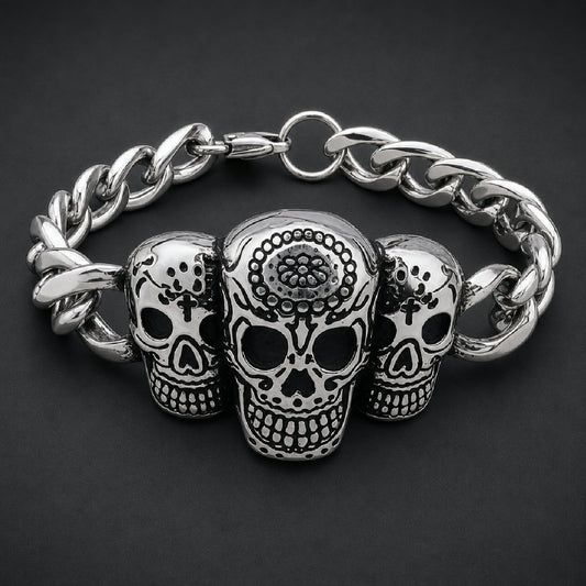 Solid 316L surgical stainless steel unisex bracelet featuring three detailed sugar skulls with floral carvings on a heavy curb link band