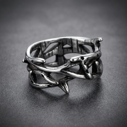 Heavy 316L stainless steel ring with an intricate, dark skeletal branch design, wrapping around the finger in an untamed, organic form.