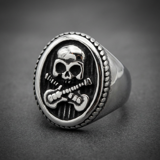 Oval signet ring with a central skull and two crossed electric guitars, 316L stainless steel with dark background.