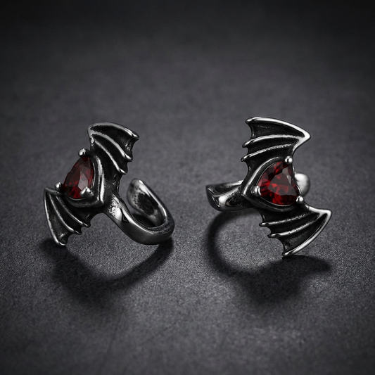 Unisex gothic bat design lip clip made from 316L stainless steel with an oxidized finish and a red teardrop gemstone.