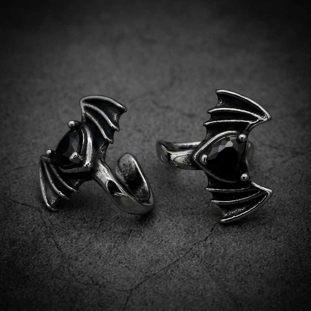 A sharp, aggressive Viper Bat Wing Lip pendant in 316L stainless steel with a dark, commanding gemstone
