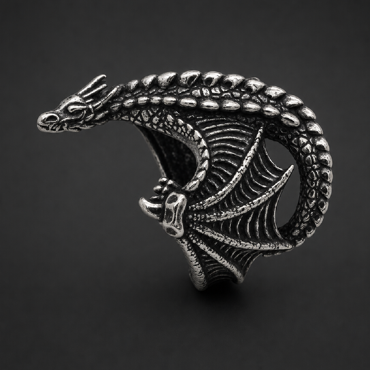 Bone Dragon Band 316L surgical stainless steel ring with antiqued finish, featuring a full-bodied dragon wrapping around the finger with detailed scales and wings.