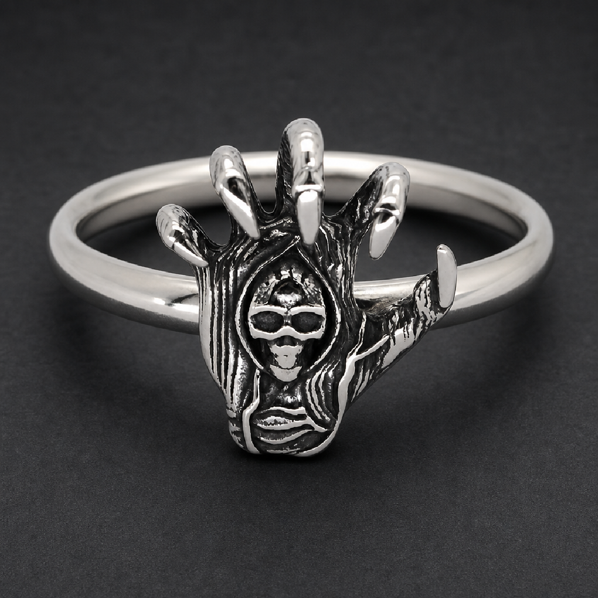 Skeletal hand with claws gripping a skull 316L stainless steel ring