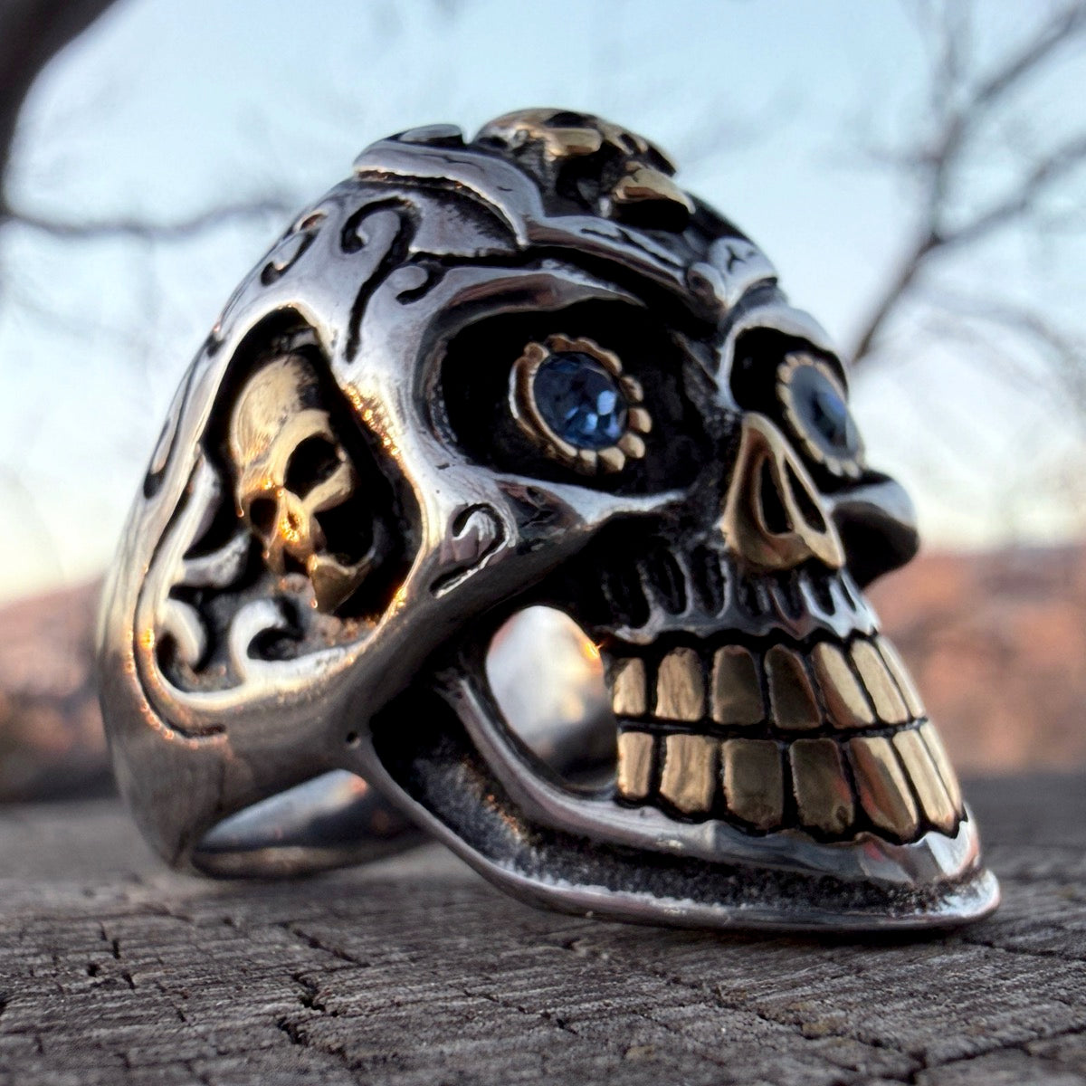 Day of the Dead skull ring with gold accents and blue eyes