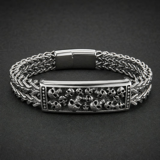 Cranium Vault Bracelet, heavy-duty 316L surgical stainless steel, wide woven chain, central rectangular plaque with detailed skull cluster, polished finish.