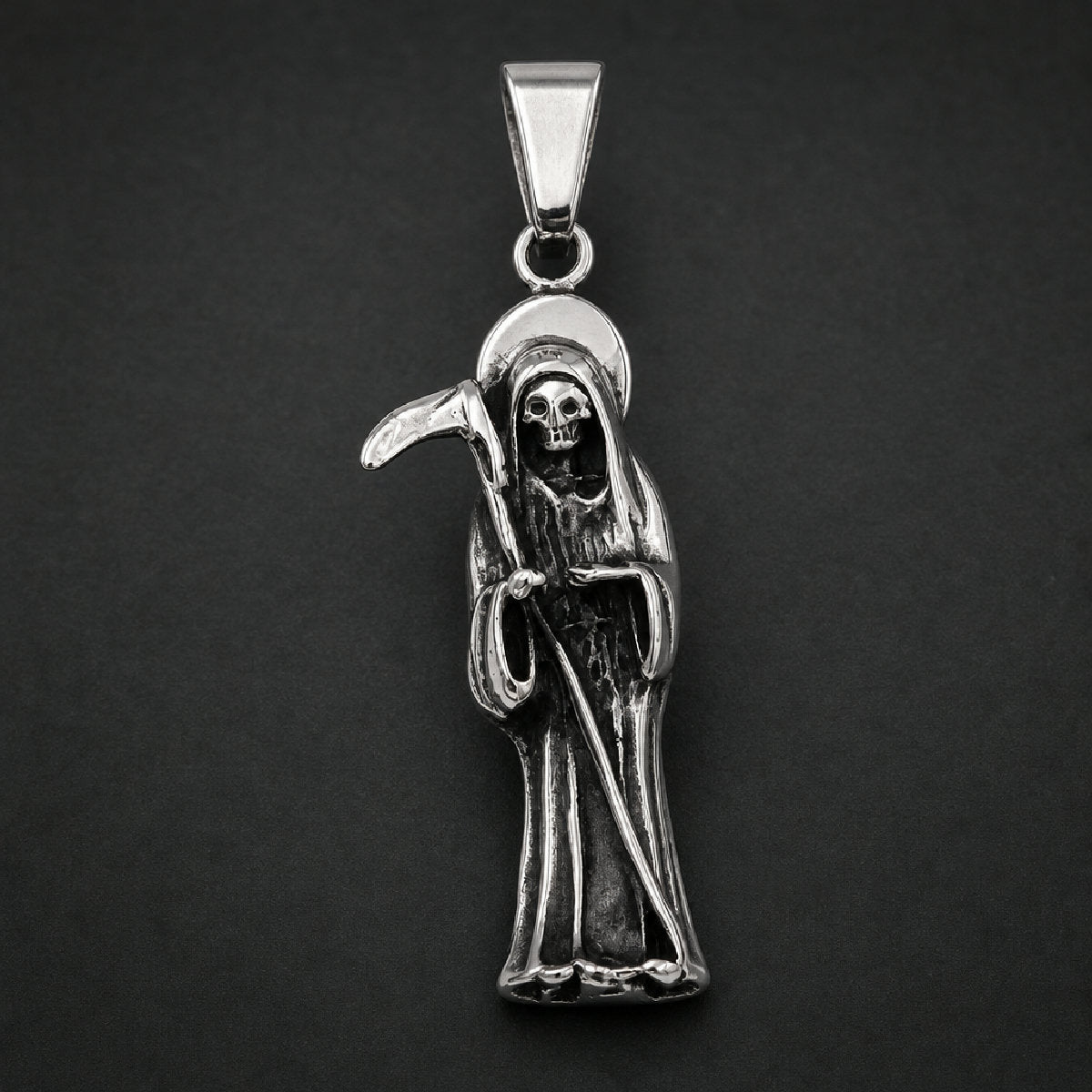 Silver and black 316L stainless steel unisex pendant depicting a cloaked harvester figure holding a scythe with an arched halo
