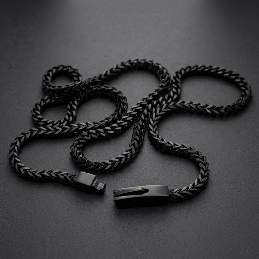 A close-up of a Darkened Franco Link Necklace made from 316L stainless steel, showcasing the interlocking V-shaped links and dark finish.