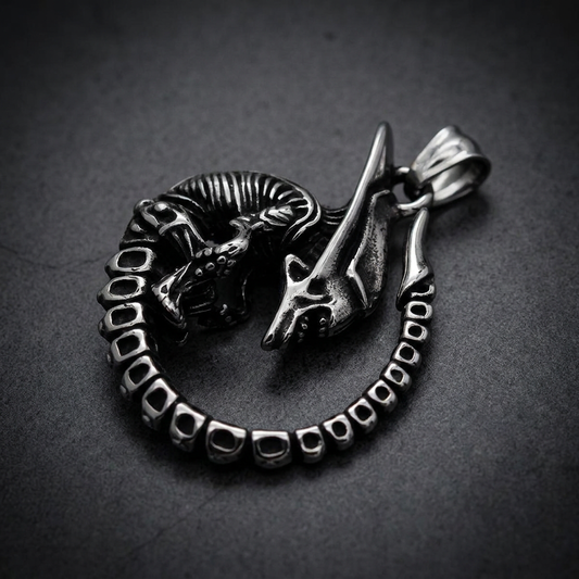 Detailed coiled dragon pendant made from polished 316L stainless steel with an oxidized silver finish, skeletal design visible.