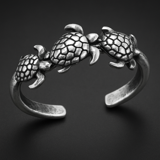 Turtle Trio Ring in 316L stainless steel featuring three intricately designed turtles symbolizing oceanic beauty.