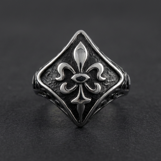 The Dark Bloom Ring, 316L stainless steel ring with oxidized fleur-de-lis motif, gothic design against a dark plain background.