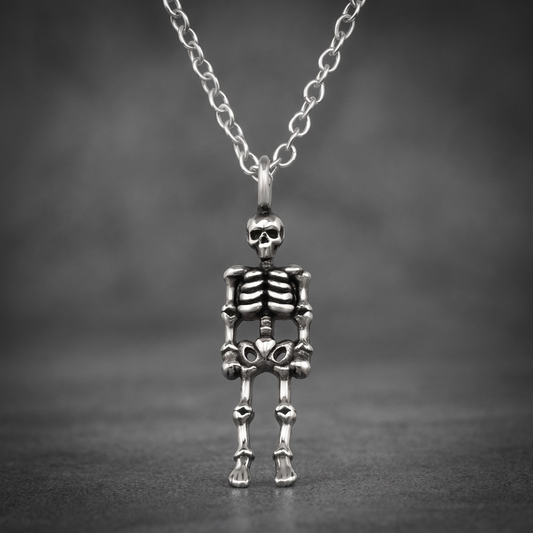 Silver 316L stainless steel flexed skeleton pendant hanging on a matching chain against a dark background.