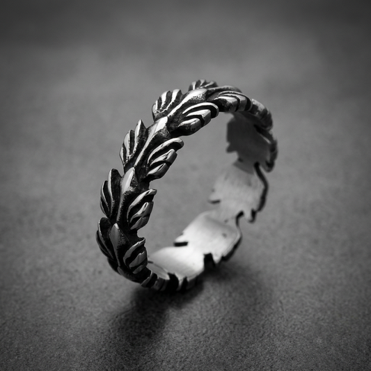 Heavy 316L stainless steel ring with intricate foliage design, dark oxidized recesses and polished edges.
