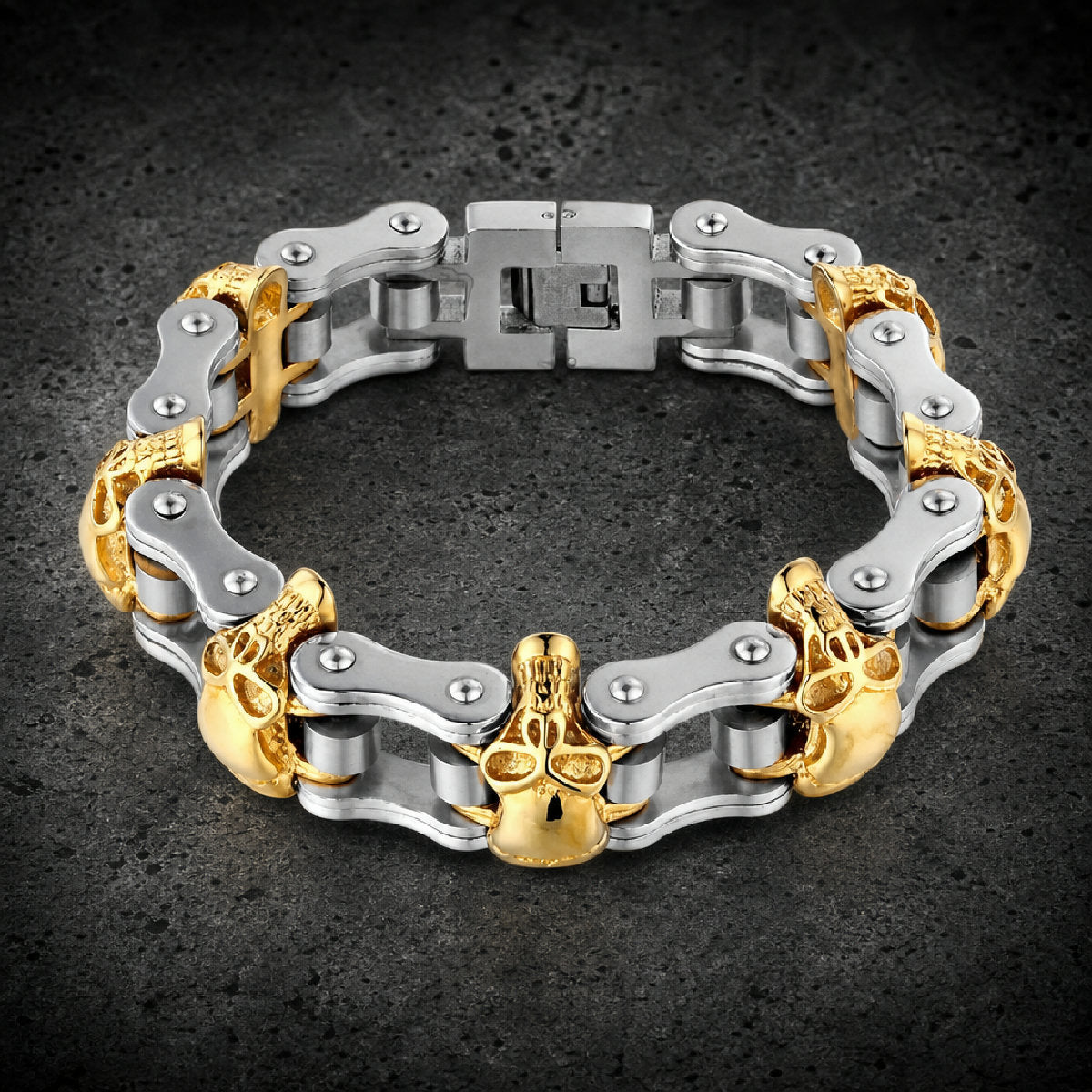 Two-tone 316L stainless steel motorcycle chain bracelet featuring gold skull accents and a fold-over clasp.