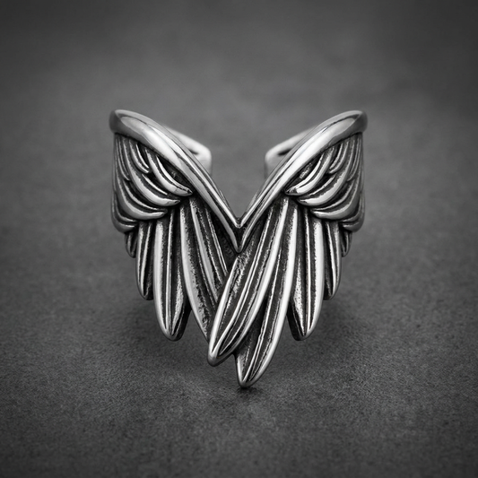Heavy-duty 316L stainless steel ring with two intricately sculpted, dark-finished wings, extending outward from a polished band, HardKnocker™ style.