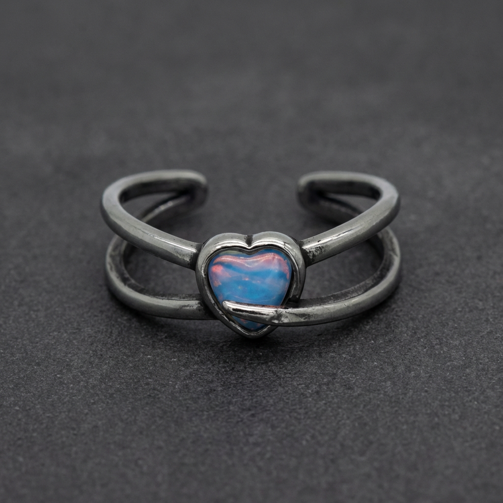 Coeur de l'Opal Ring featuring a dual-banded 316L stainless steel design with a captivating blue and pink iridescent opal heart at its center.