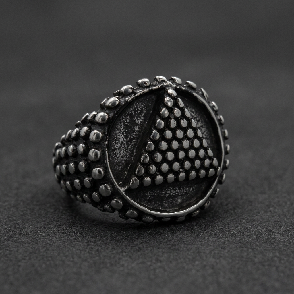 Stainless steel pyramid ring with textured dotted pattern.