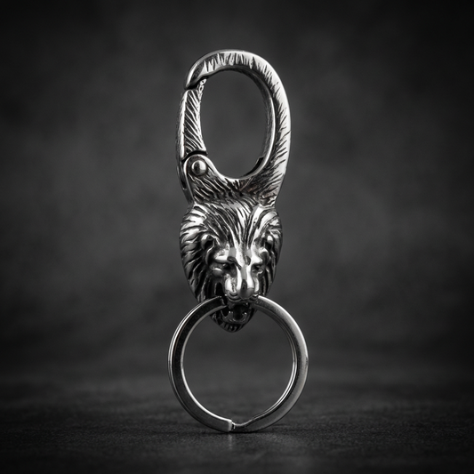 A detailed close-up of the Royal Ascent Lion Head Keychain, showcasing the intricately carved majestic lion's head made from 316L stainless steel with oxidized details.
