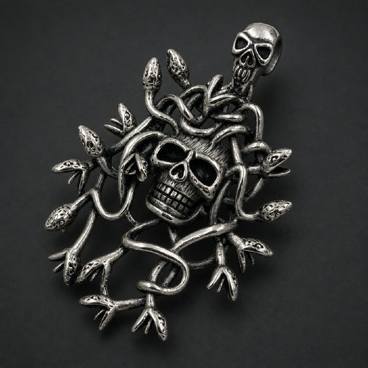 Solid 316L stainless steel Gorgon skull pendant featuring writhing coiled serpents, blackened oxidation, and integrated skull bail.