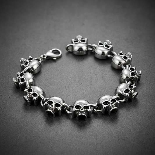 Multiple polished stainless steel skulls linked together forming a bracelet, featuring darkened eye sockets and a lobster clasp.