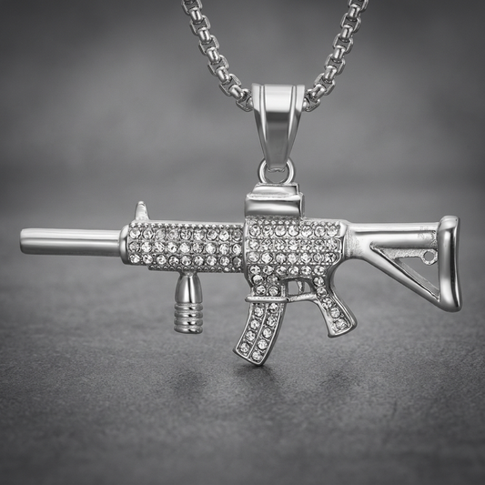 Silver 316L stainless steel carbine rifle pendant, fully studded with clear crystals, shown on a chain.