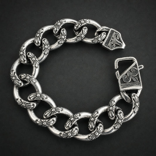 Heavy 316L stainless steel bracelet with intricate floral cross-like etched links and a decorated clasp, bright silver finish.