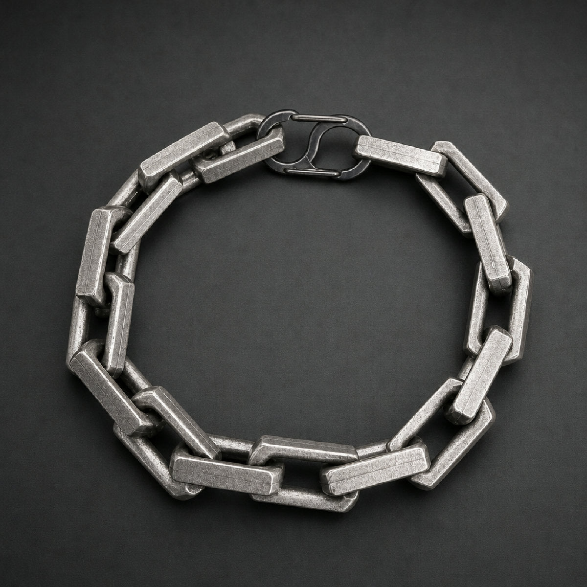 Heavy 316L stainless steel block link chain bracelet with a toggle clasp and brushed finish on a wooden surface