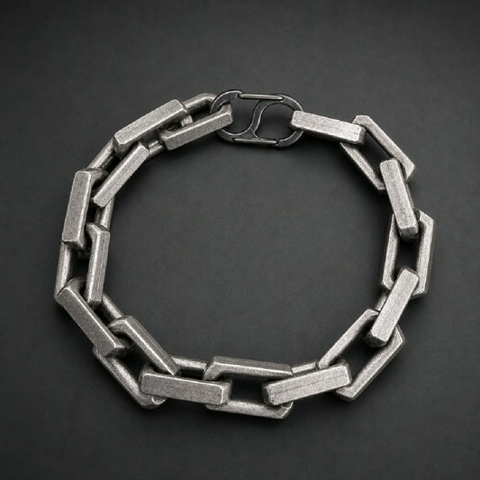 Heavy 316L stainless steel block link chain bracelet with a toggle clasp and brushed finish on a wooden surface