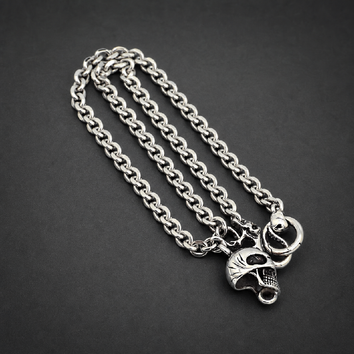 Memento Mori Band, heavy 316L stainless steel ring with a stylized skull motif and textured side details, HardKnocker construction, bright silver finish.