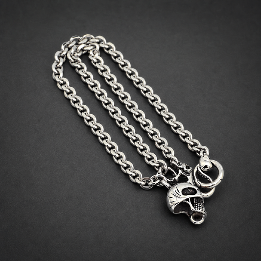 Memento Mori Band, heavy 316L stainless steel ring with a stylized skull motif and textured side details, HardKnocker construction, bright silver finish.
