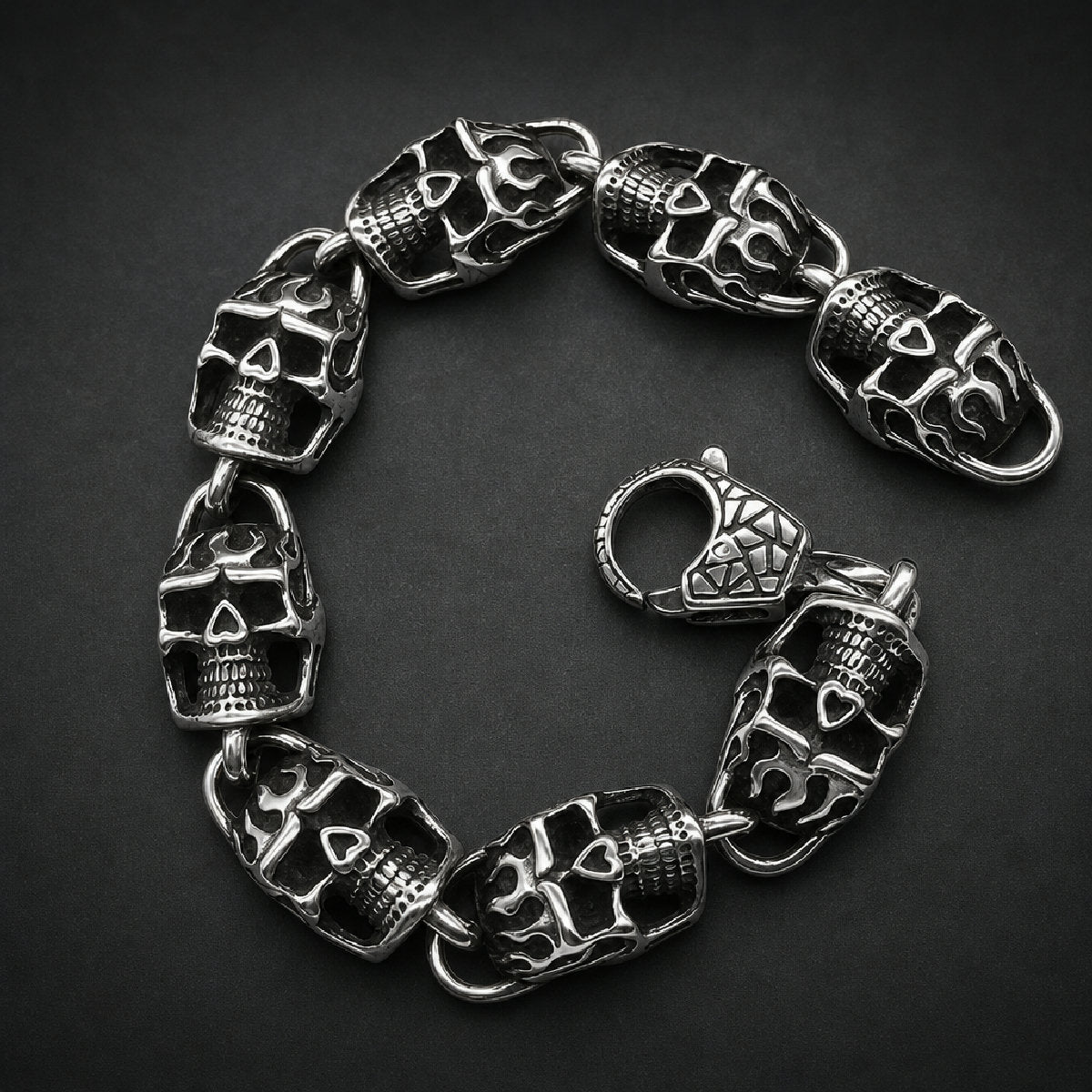 Interlocking flame skull bracelet in polished and blackened 316L surgical stainless steel with heavy lobster clasp