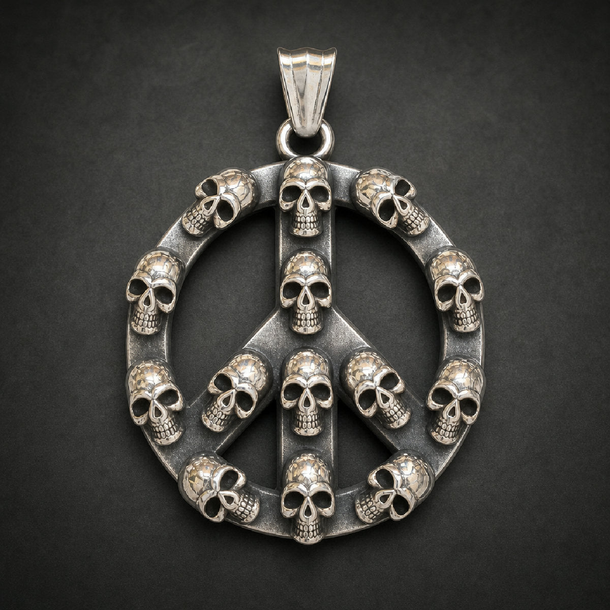 Memento Mortem Pendant, a unisex 316L stainless steel pendant featuring a peace sign design with many small skulls forming its structure and border, with a polished silver finish.