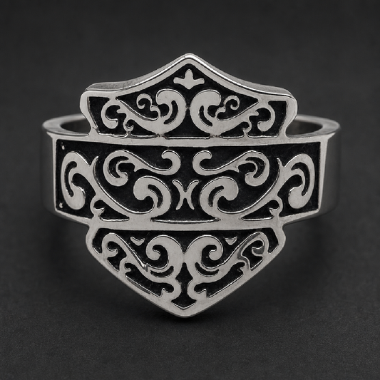 Close-up of The Iron Crest Scroll Ring, a bold shield-shaped ring crafted from 316L surgical stainless steel with intricate dark scrollwork.