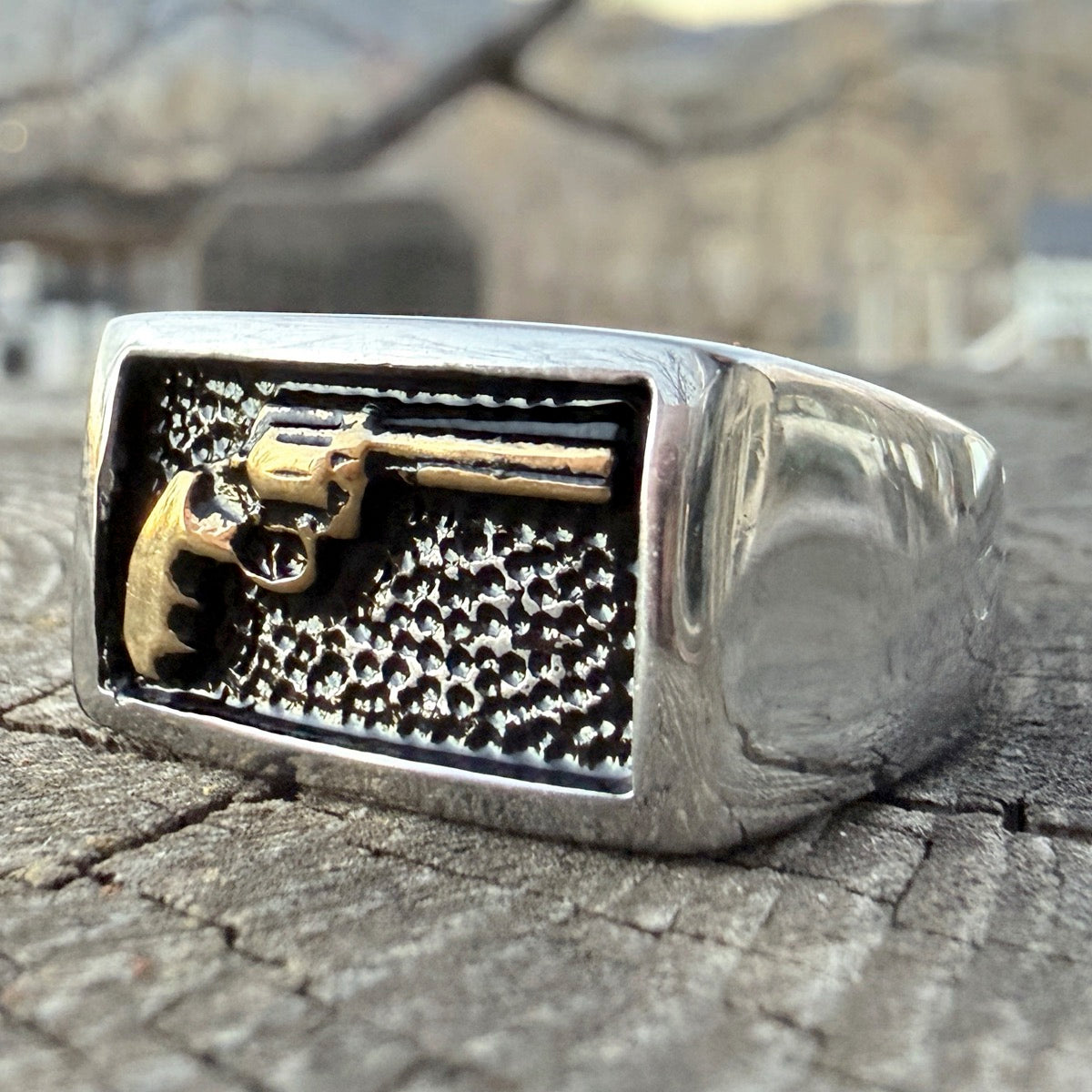 Rectangular signet ring featuring a gold-tone revolver detail