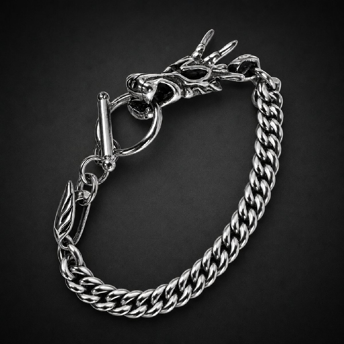 Heavy 316L surgical stainless steel bracelet featuring a detailed dragon head design on one end and a t-bar clasp, with a thick wheat chain.