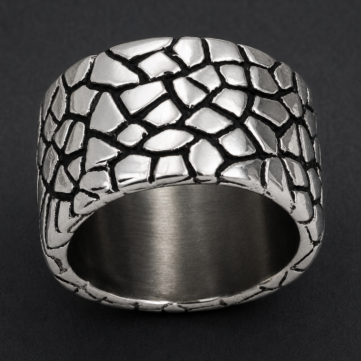 Wide 316L stainless steel Cracked Armor Band ring with polished, irregular segments and darkened recesses on black background.