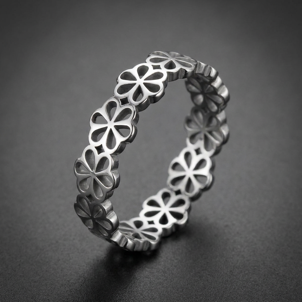 Nobel Clover Band, 316L stainless steel unisex ring with an intricate, repeating four-petal clover motif cut-out design and a high-polish finish.