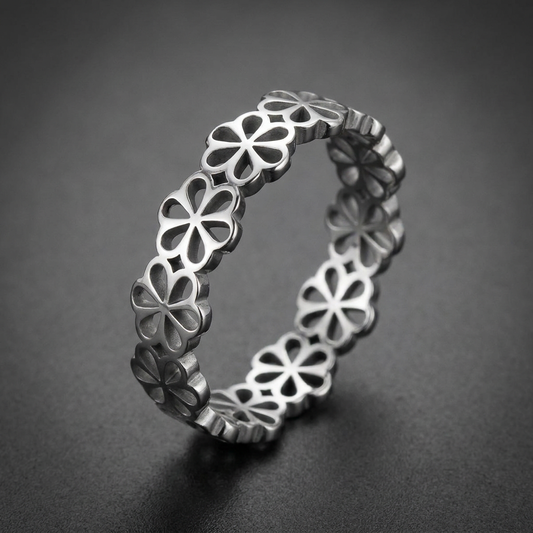 Nobel Clover Band, 316L stainless steel unisex ring with an intricate, repeating four-petal clover motif cut-out design and a high-polish finish.